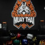 Muay thai art on the wall, below them there are medical balls